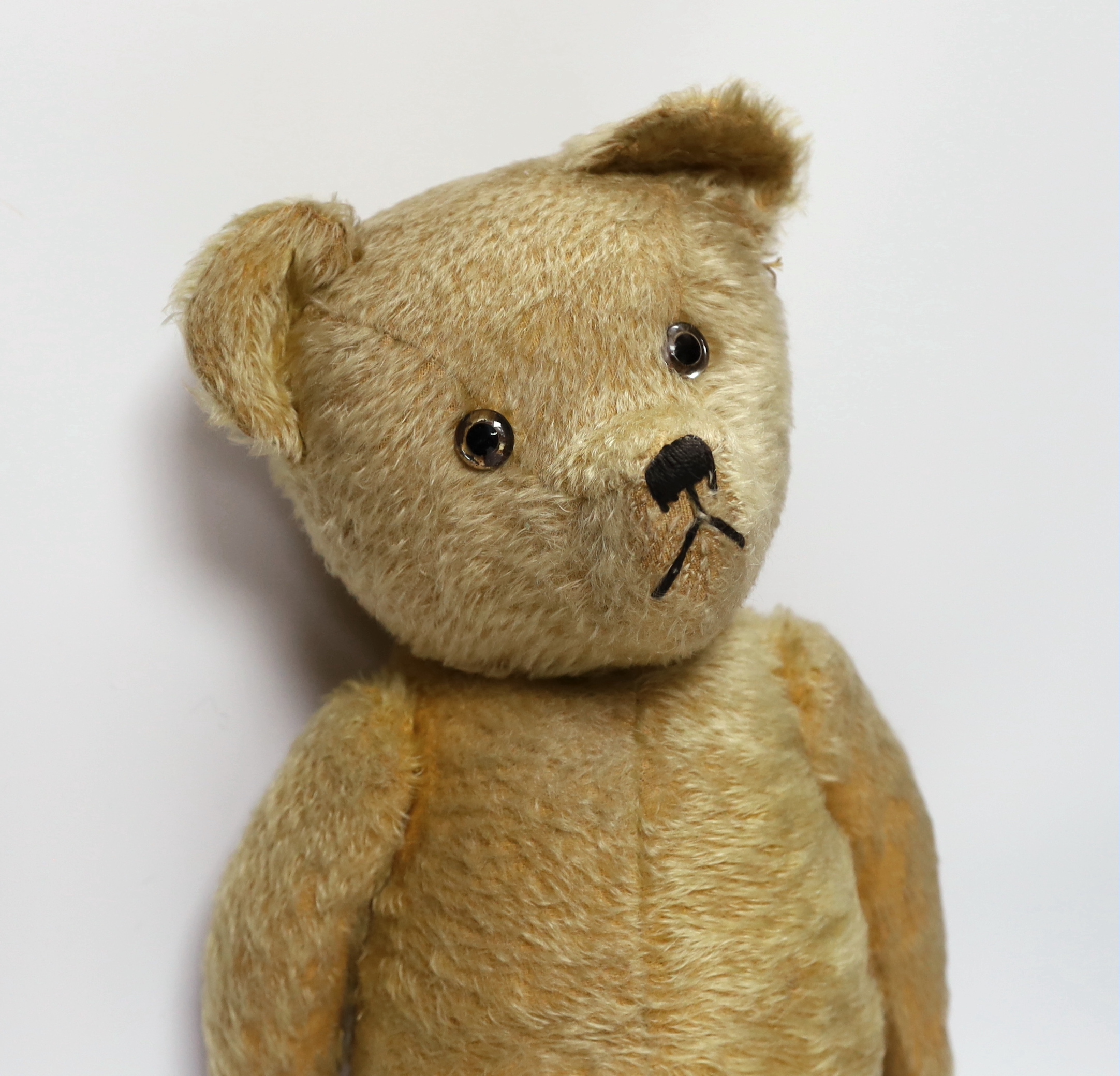 A golden plush bear, worn, 60cm